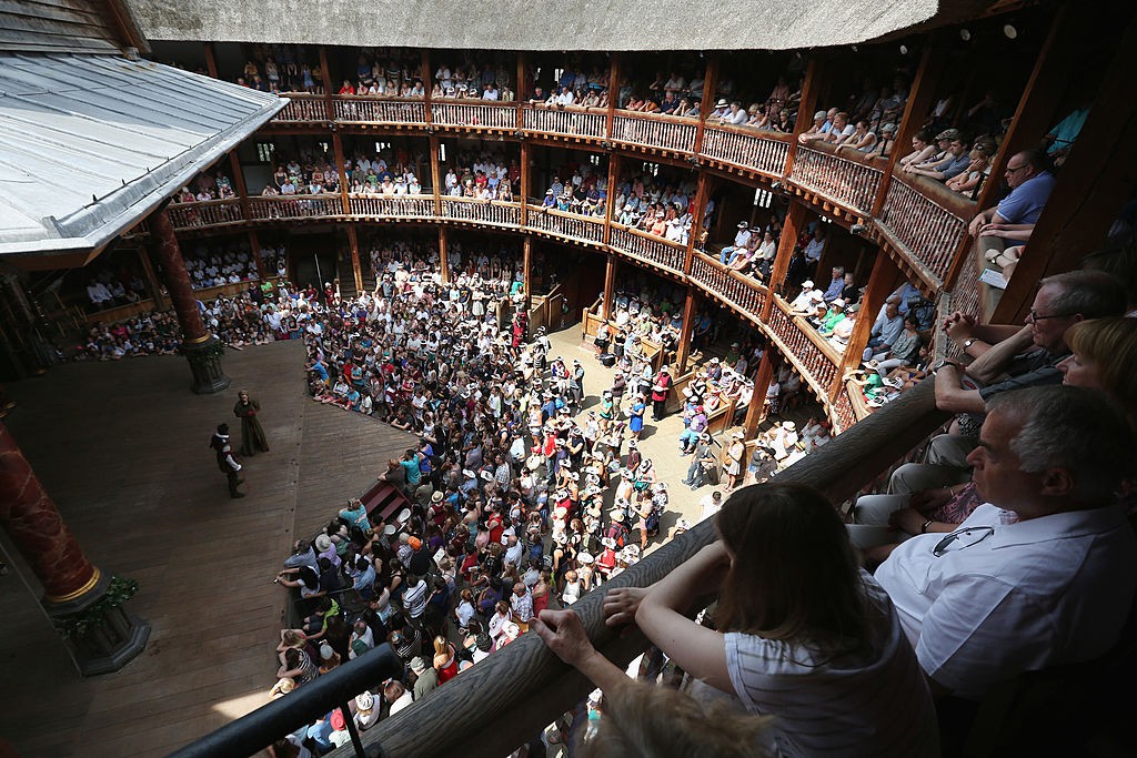 Theatregoers Enjoy The Sunshine During A Performance At The Globe