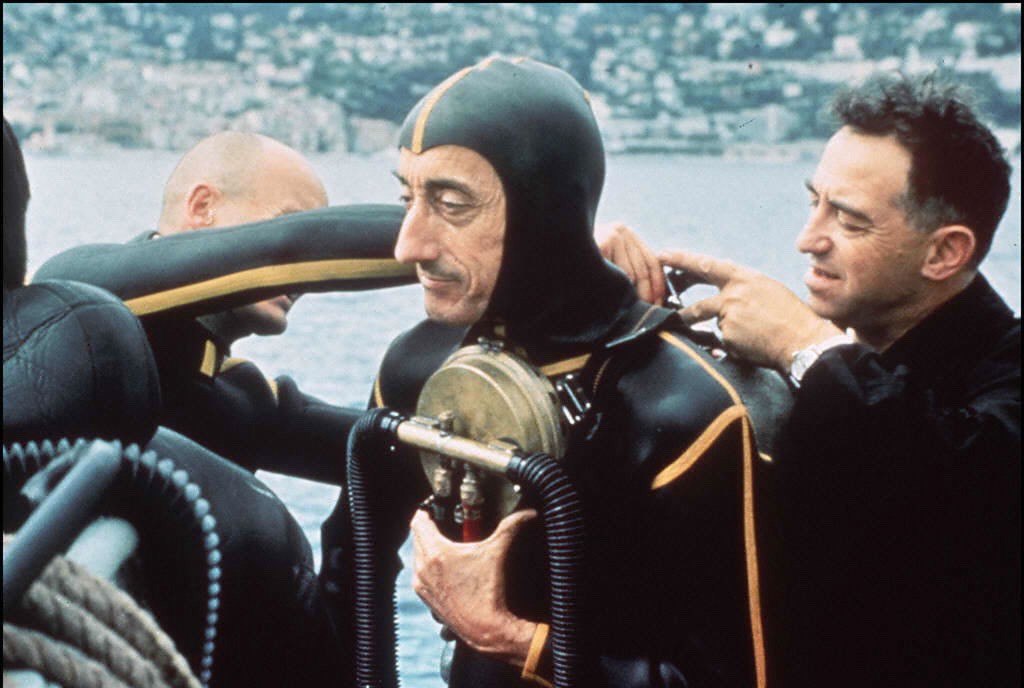 Oceanographer Jacques Yves Cousteau, adjusts his diving gear