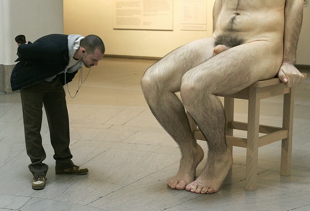 A visitor looks at a giant sculpture tit