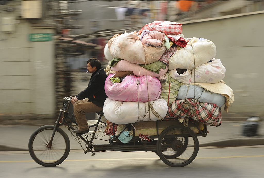 A man transports clothing for recycling